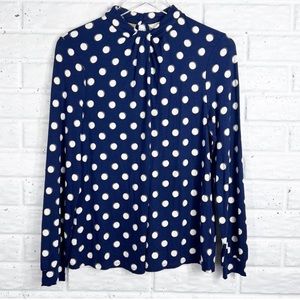 Boden navy polka dot long sleeve shirt with a twist neckline.